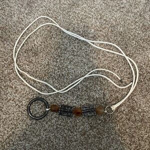 White string rope belt with silver and amber brown detail. Some tarnishing